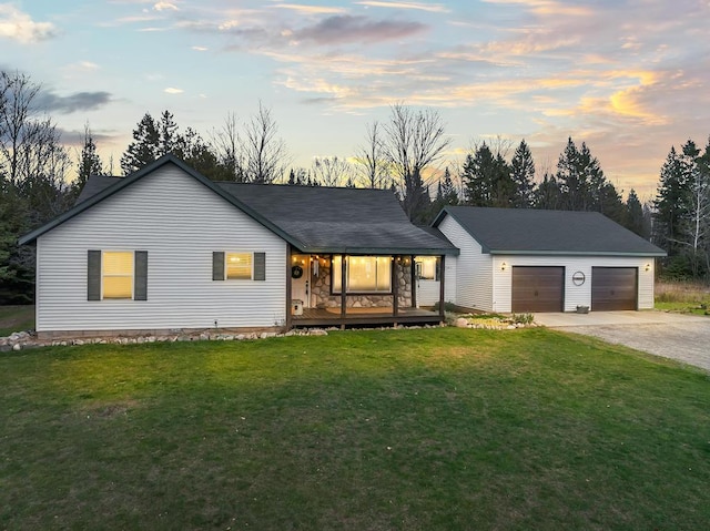 ranch-style house with a garage and a yard