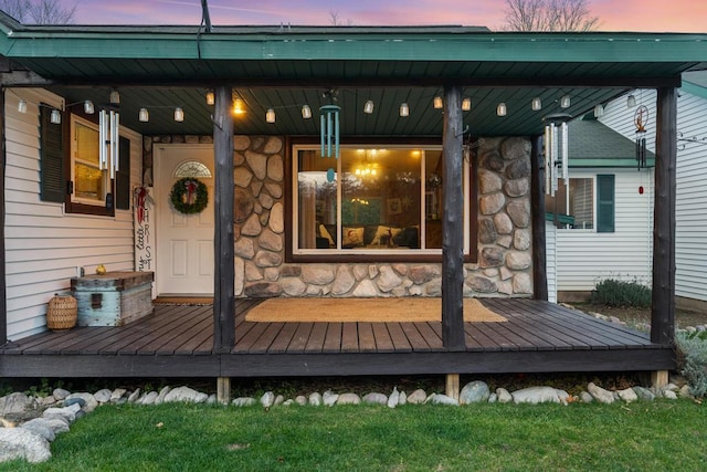 exterior entry at dusk with covered porch