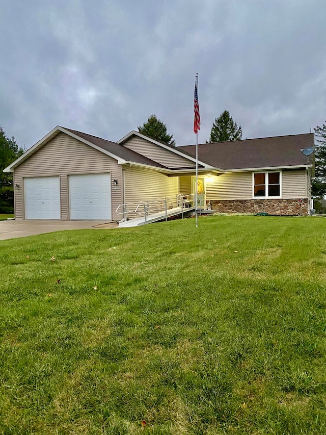 ranch-style home featuring a garage and a front lawn