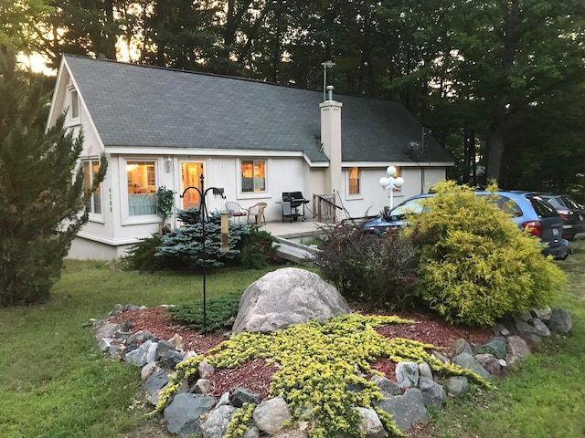 back of house featuring a lawn and a patio area