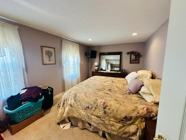 carpeted bedroom with a textured ceiling