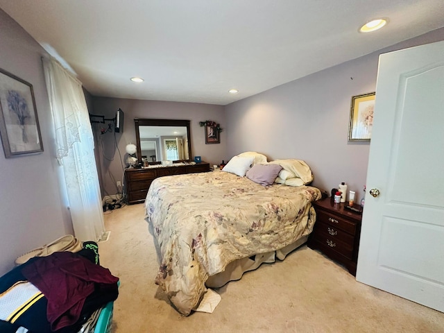 bedroom featuring light carpet