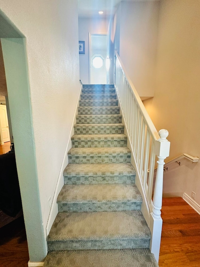 stairway featuring wood-type flooring