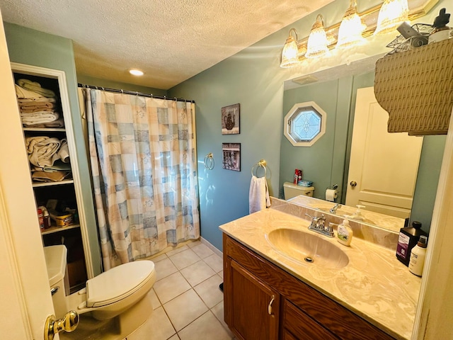 bathroom with a textured ceiling, curtained shower, vanity, tile patterned floors, and toilet