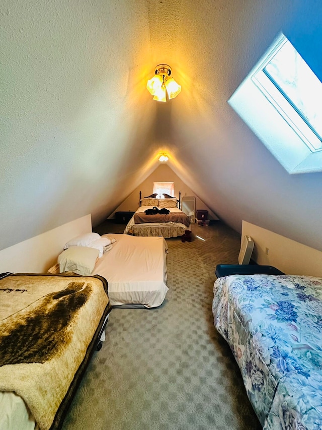 bedroom featuring vaulted ceiling with skylight, a textured ceiling, and dark carpet