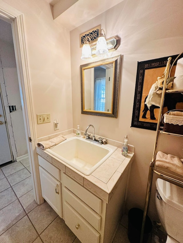 bathroom featuring tile patterned flooring, vanity, and toilet