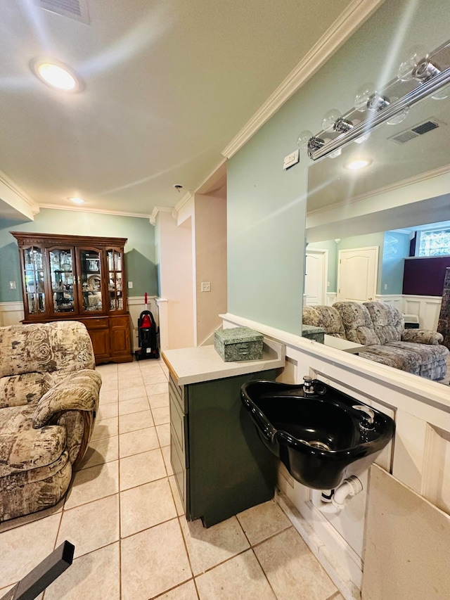 interior space with sink, light tile patterned floors, and crown molding