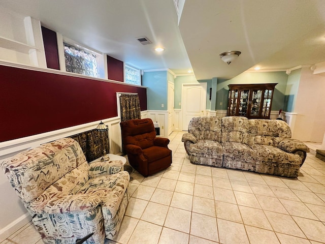 living room featuring ornamental molding and light tile patterned flooring