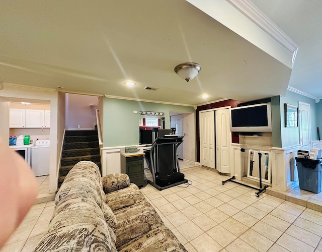 tiled living room featuring crown molding, a healthy amount of sunlight, and washer / clothes dryer