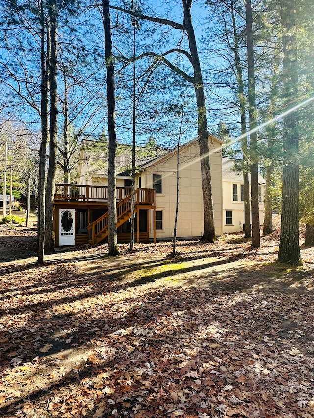 rear view of house featuring a wooden deck