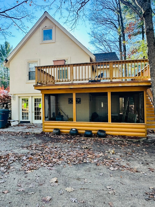 back of house featuring a deck and a sunroom