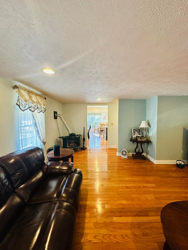 living room featuring a textured ceiling, hardwood / wood-style flooring, and plenty of natural light