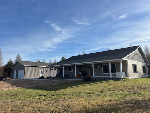 view of front of property with a garage, a porch, and a front lawn