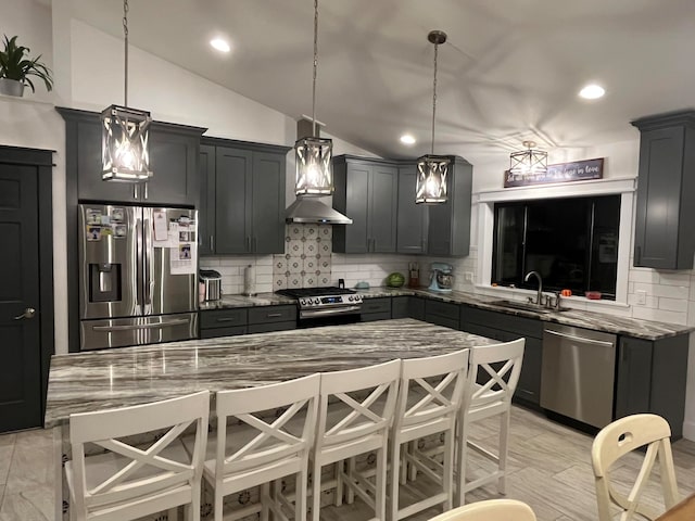 kitchen featuring sink, vaulted ceiling, stainless steel appliances, and stone countertops