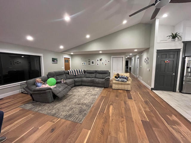 living room featuring ceiling fan, hardwood / wood-style floors, and high vaulted ceiling