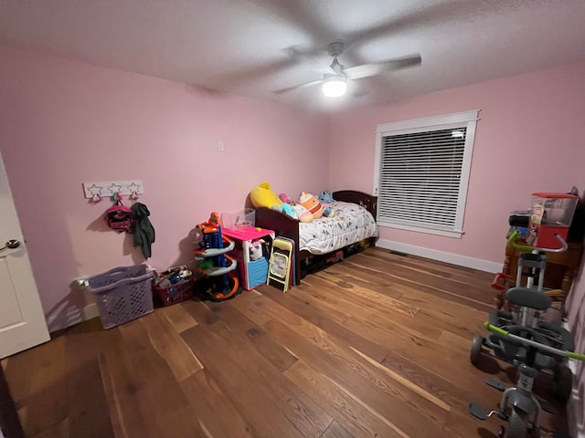 bedroom with hardwood / wood-style flooring and ceiling fan