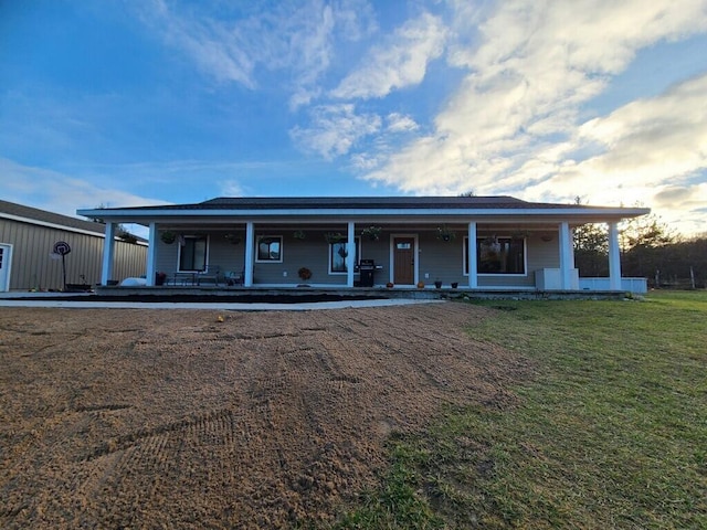 view of front of house featuring a front yard and covered porch