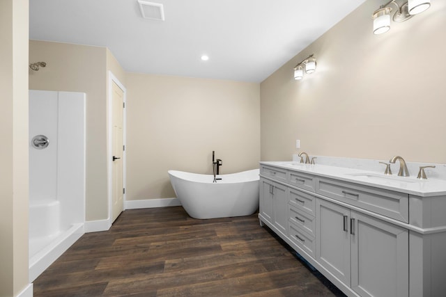 bathroom featuring a bathing tub, vanity, and wood-type flooring