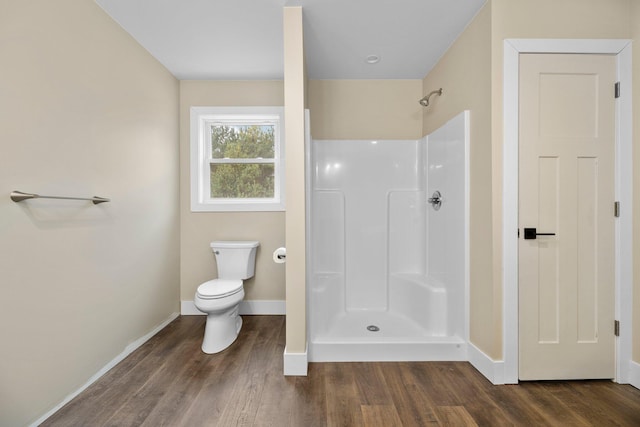 bathroom with wood-type flooring, toilet, and walk in shower