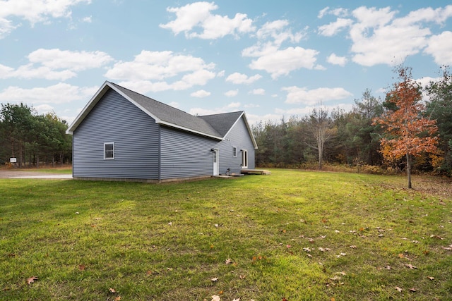 view of side of home featuring a lawn