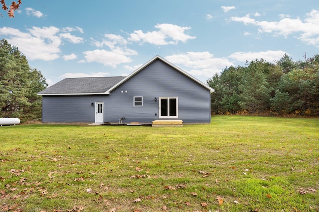 rear view of house with a yard