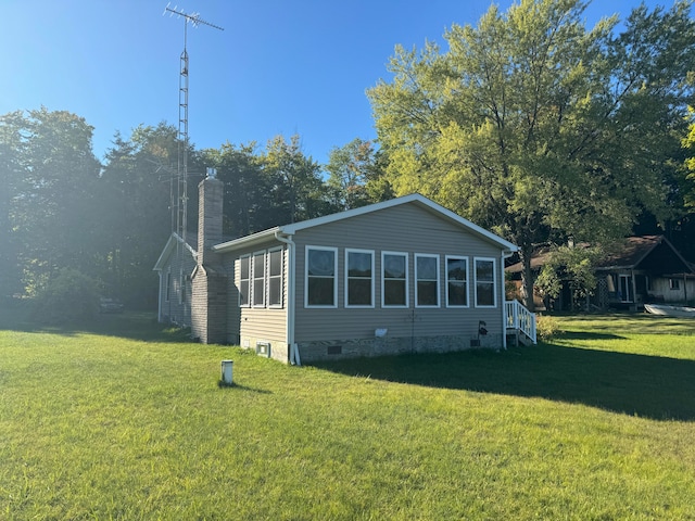 rear view of house featuring a yard