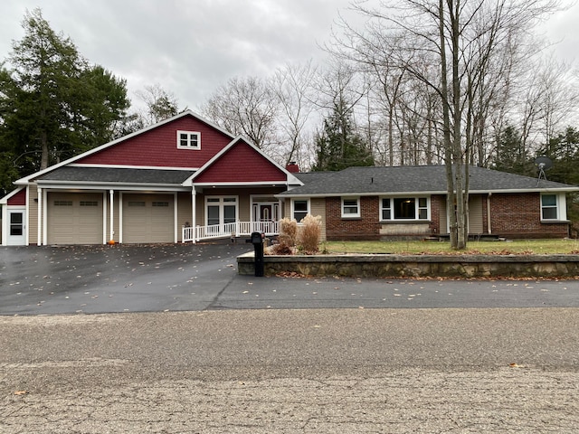 view of front of house with a porch and a garage