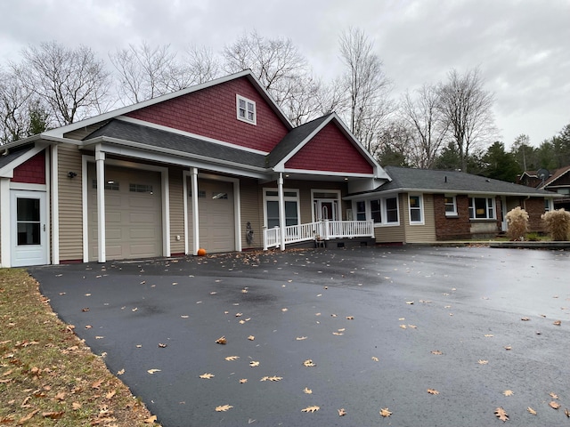 view of front of home with a porch and a garage