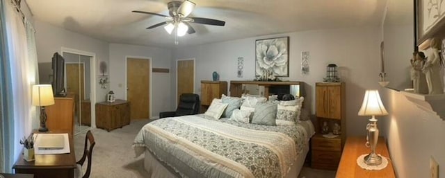 bedroom with ceiling fan and light colored carpet