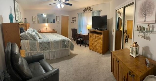 bedroom with ceiling fan, a closet, and light colored carpet