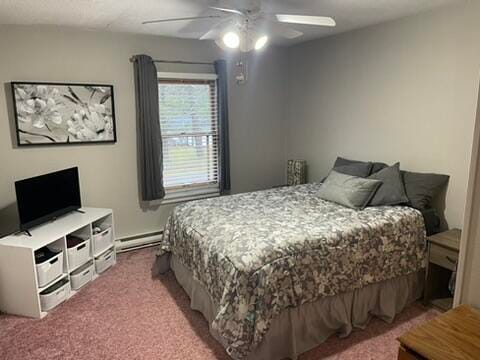 bedroom with carpet, baseboard heating, and ceiling fan