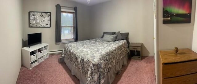 carpeted bedroom featuring a baseboard heating unit