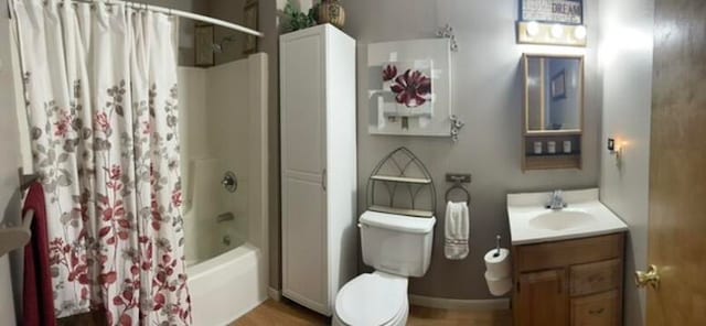 full bathroom featuring vanity, wood-type flooring, shower / tub combo, and toilet