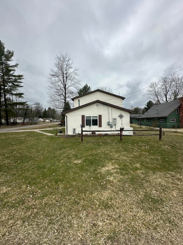 view of side of property featuring a yard