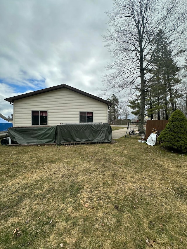 view of side of property featuring a yard