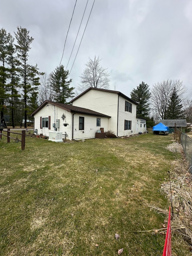 rear view of property with a lawn