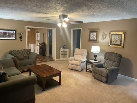 carpeted living room featuring a textured ceiling and ceiling fan