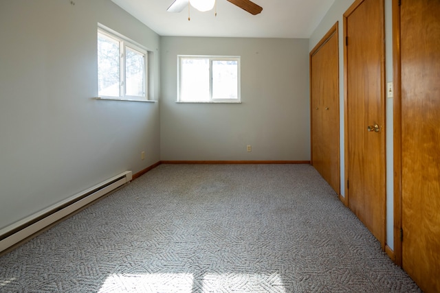 unfurnished bedroom featuring a baseboard radiator, ceiling fan, and light colored carpet