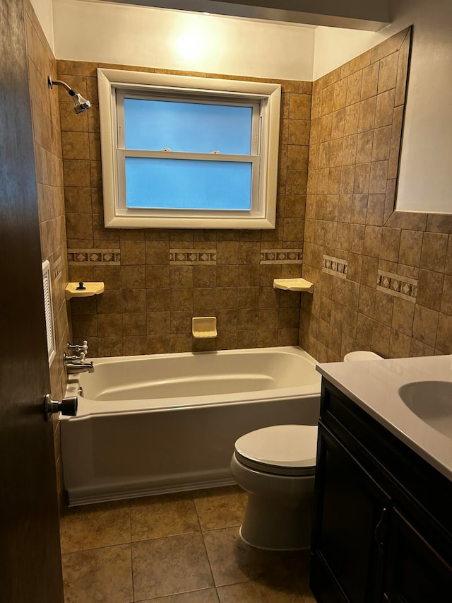 full bathroom with tile patterned flooring, tiled shower / bath combo, and tile walls