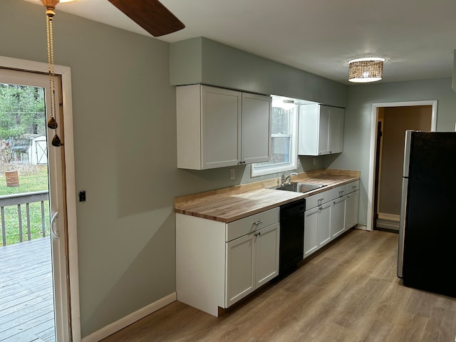 kitchen featuring white cabinetry, dishwasher, light hardwood / wood-style flooring, wooden counters, and stainless steel fridge