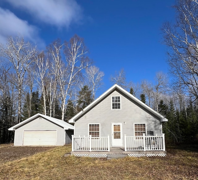 view of front of property with a deck, an outdoor structure, and a garage