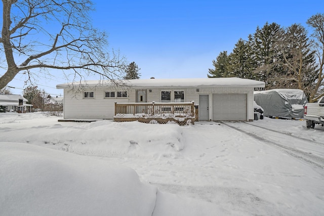 view of front of home with a garage and a deck