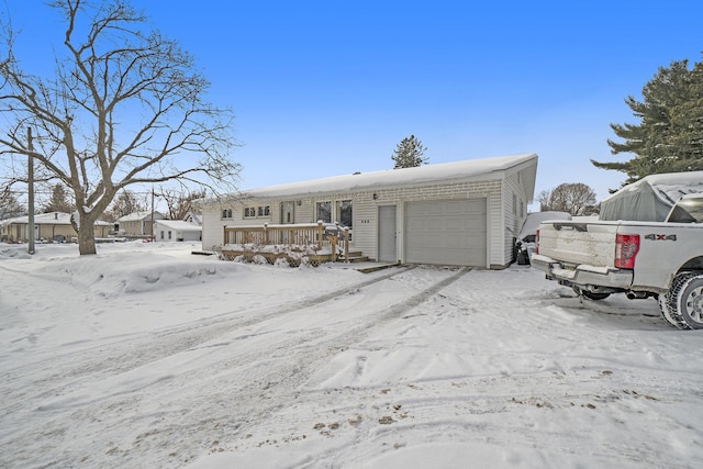 view of front of house featuring a garage and a wooden deck