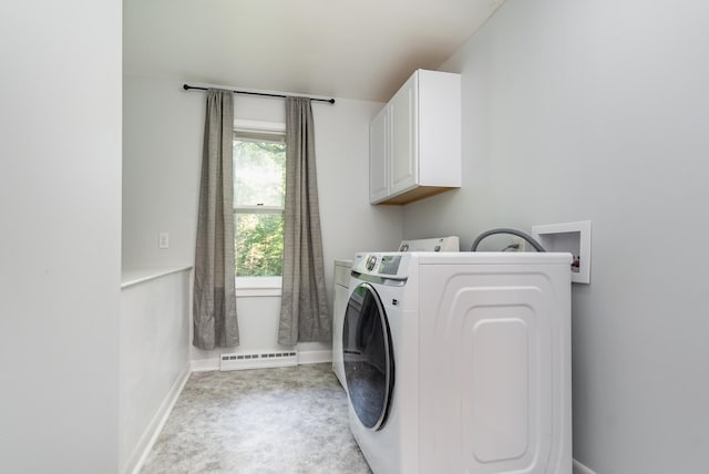 washroom featuring washer and clothes dryer and cabinets