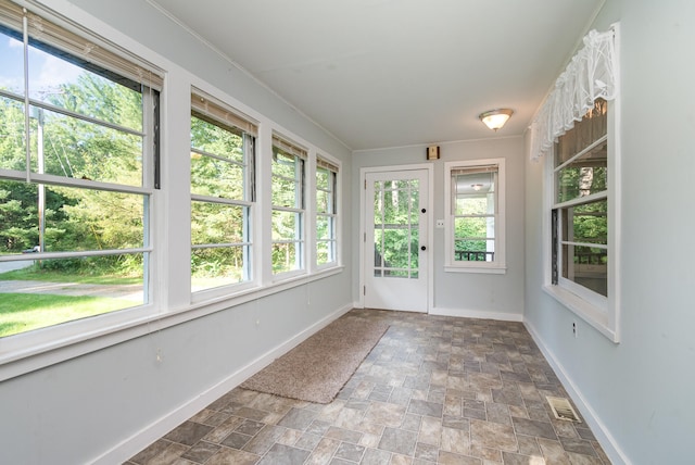 unfurnished sunroom with a wealth of natural light