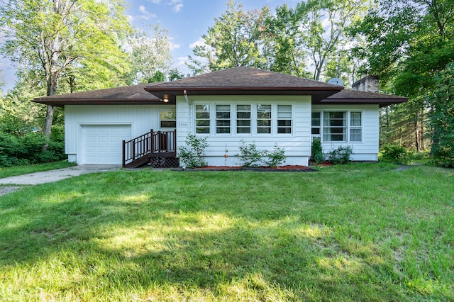 view of front of home with a front yard and a garage