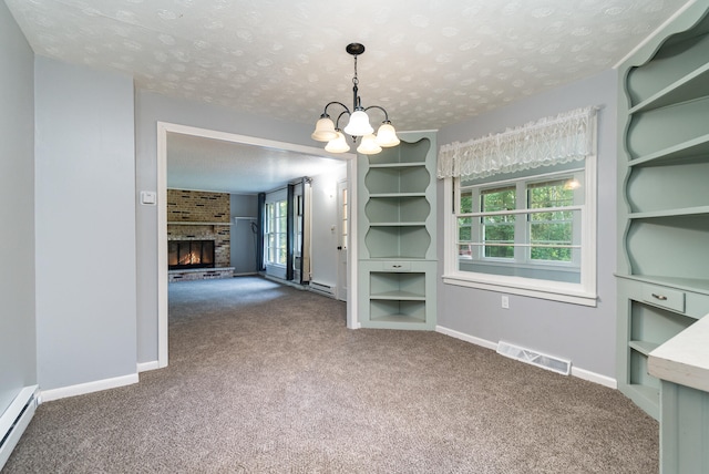 interior space with an inviting chandelier, a brick fireplace, carpet flooring, a textured ceiling, and a baseboard radiator