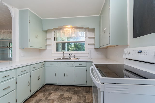 kitchen featuring decorative backsplash, sink, and white range