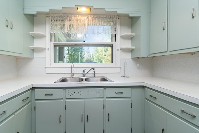 kitchen featuring backsplash and sink