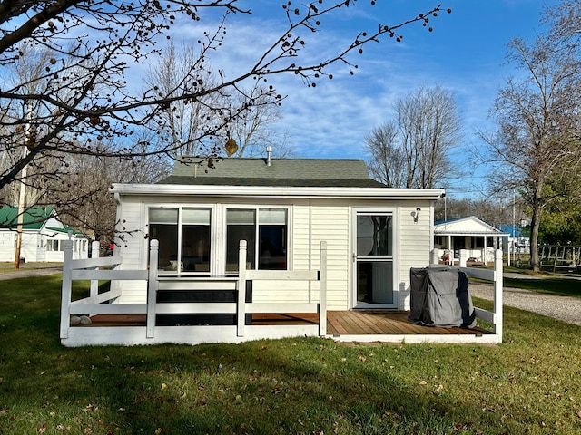 rear view of property with a lawn